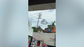 Bizarre black ring of smoke appears in sky after ship burns and sinks