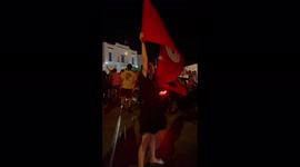 Girl holds the Tunisian flag over her head during a demonstration in La Marsa, Tunisia