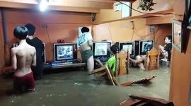 Online gaming addicts in net cafe continue playing through TYPHOON flood