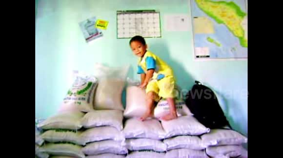 A little boy learning how to jump off his parents pile of rice. - Buy ...