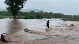Indian officials rescue 'drunk' man trying to cross floods in central India
