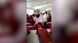 Over-diligent maid of honour picks up bride’s train as she walks down the aisle in the Philippines