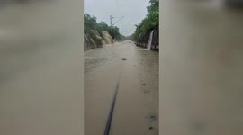 Railway track submerged by cascading floodwater in central India