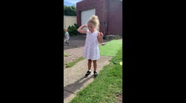 Little girl with a whistle pretending to be a train conductor