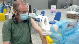 Getting vaccinated against Covid 19 in Bangkok Thailand at a trainstation..