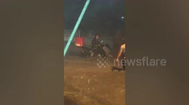 Delivery rider gets stuck on flooded road as monsoon rain submerges village in the Philippines
