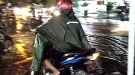 A Biker Try to Go Far Away From Flood