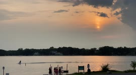Watch as jet skiers enjoy dazzling sunset on Diamond Lake in Illinois