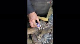 Blacksmith lights fire by hammering iron and pressing it against matches