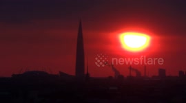 Red eye of the sunset appeared over Lakhta tower in St Petersburg, Russia