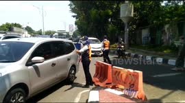 Jakarta traffic officials enforce odd-even numberplate policy to reduce activity