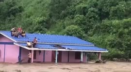 Dramatic moment father and child are rescued from flooded home