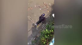 Brave traffic police save family from being washed away by river in Malaysia