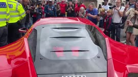 Cheering fans surround Arsenal footballer Alexandre Lacazette as he arrives at Emirates Stadium