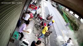 Chinese woman narrowly escapes as fence at construction site collapses onto road