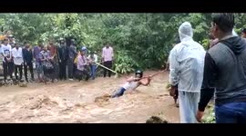 Watch - People rescued with the help of rope after sudden water wave