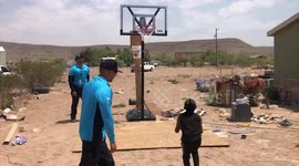 US technicians buy 9-year-old boy a basketball court after spotting him playing with a bucket on a stick