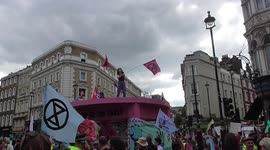 girl dancing on giant pink table Excitation Rebellion protest