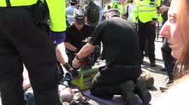 London police use drills to separate climate protesters with arms lodged in pipes