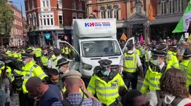 Eco-protesters close Cambridge Circus at least 2 of them lock themselves to large item on the road