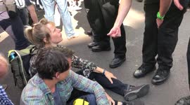Extinction Rebellion protesters are removed from the road by police after they blocked Cambridge Circus in London