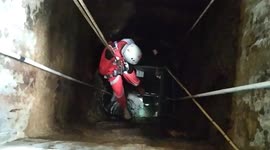 Indonesian volunteers try to help a cat fell into a 26-foot well, but..