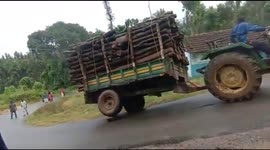 Driver jumps to safety as overloaded tractor rolls out of control and overturns with a bang