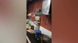 Water pours into family’s kitchen during rainstorm in northeastern Thailand