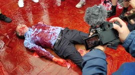 A man swimming in a pool of fake blood of money