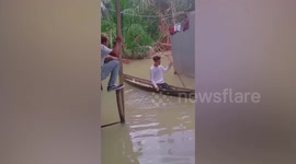 Man plunges into flood water as he tries to help friend to safety in Indonesia
