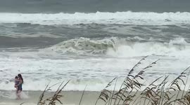My daughter and kid at destin beach, watching wave action from hurricane Ida today at 11:45 am