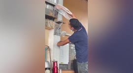 Man tries to help mouse while it is being eaten by snake