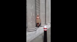 topless protester Extinction rebellion poses on the bank of england
