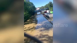 A lorry driver was rescued from his cabin by a stranger after he got stuck in a flood