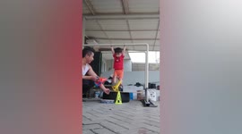Toddler shows off acrobatic skills in work-outs with dad in Indonesia