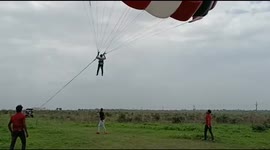A boy is gliding in air with the help of car,