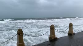 Cottesloe Beach surging waves crashing into wall on a stormy winters day