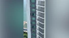 Amusing moment angry Brit yells at barking dogs from his 23rd-floor balcony