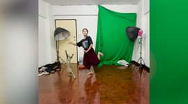 Pet cat distracts owner while she does elegant Thai dance