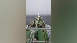Waterspout tornado forms as cargo ship sails past in Thailand