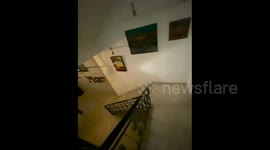 Palestinian artist Khaled Hussein, displays his artworks in an exhibition, Gaza