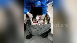 Customs officers stop travellers attempting to smuggle bottles of liquor into China
