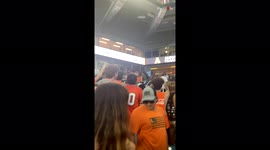 Crowd bursts into cheers as Miami Hurricane fans catch a falling cat in US flag