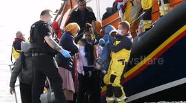 RNLI returns from picking up immigrants and unloading four children and women safely to the beach where they will be processed