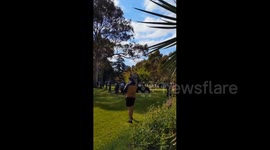 Protesters shout slogans at the Memorial Monument as police kneel in Melbourne, Australia