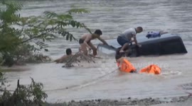Men rescued from car sinking in flooded river