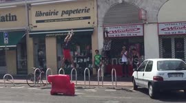 Men use bike racks for gymnastics on the streets of Nice, France