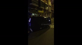 Car lifted onto side by group to free trapped friend