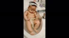 Adorable 3-month-old baby cools off in basin