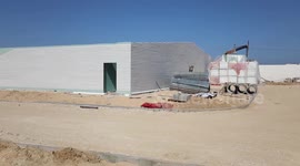 Palestinians work on the building the field hospital to house coronavirus disease (COVID-19), patients
